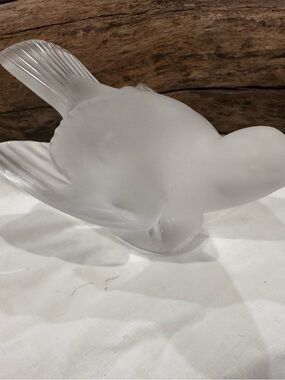 Lalique Crystal Sparrow crafted in frosted satin-finished.
